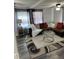 Bright living room features stylish furniture and a large area rug at 8218 N 18Th St, Tampa, FL 33604
