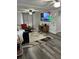Living room with large TV, comfortable seating and a modern fireplace at 8218 N 18Th St, Tampa, FL 33604