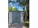 Gray storage shed with double doors in backyard at 8218 N 18Th St, Tampa, FL 33604