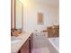 Modern bathroom with double vanity, large mirror, and bathtub at 111 N 12Th St # 1708, Tampa, FL 33602