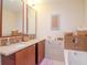 Modern bathroom with double vanity, large mirror, and bathtub at 111 N 12Th St # 1708, Tampa, FL 33602