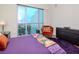 Spacious bedroom with large windows offering city views, plush bedding, and ample storage at 111 N 12Th St # 1708, Tampa, FL 33602