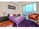 Comfortable bedroom with city views and an accent chair at 111 N 12Th St # 1708, Tampa, FL 33602