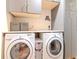 Modern laundry room with stacked washer and dryer, ample storage at 111 N 12Th St # 1708, Tampa, FL 33602