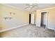 Well-lit bedroom with wall-mounted shelves and a ceiling fan at 11822 Raintree Dr, Temple Terrace, FL 33617