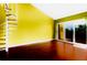 A spacious living room with a spiral staircase and a sliding glass door leading to a balcony at 1710 Lighthouse S Ter # 1, South Pasadena, FL 33707