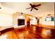 Spacious living room with fireplace, hardwood floors, and staircase leading to upper level at 1710 Lighthouse S Ter # 1, South Pasadena, FL 33707