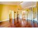 Bright living room with hardwood floors and spiral staircase leading to a loft or upper level at 1710 Lighthouse S Ter # 1, South Pasadena, FL 33707