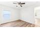 Spacious bedroom with wood-look floors and a window at 1753 Broad Winged Hawk Dr, Ruskin, FL 33570