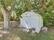 Small, white shed in the backyard, providing extra storage for tools and equipment at 2152 74Th N St, St Petersburg, FL 33710