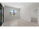This bedroom features neutral colors and tile floors and sliding glass doors at 2748 Winding Creek Trl, North Port, FL 34289