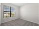 Bright bedroom featuring a neutral color palette, carpeted floor and a window with blinds at 2748 Winding Creek Trl, North Port, FL 34289