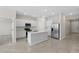 Modern kitchen with white cabinetry, stainless steel appliances, and a center island at 2748 Winding Creek Trl, North Port, FL 34289