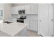 Modern kitchen featuring white cabinets, stainless steel appliances, and a center island with a sink at 2748 Winding Creek Trl, North Port, FL 34289