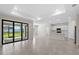 Bright living room featuring tile floors, recessed lighting, and sliding glass doors to the backyard at 2748 Winding Creek Trl, North Port, FL 34289
