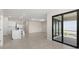 Bright living room featuring tile floors, recessed lighting, with a view to the kitchen and sliding glass doors at 2748 Winding Creek Trl, North Port, FL 34289
