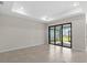 Bright living room featuring tile floors, recessed lighting, and sliding glass doors to the backyard at 2748 Winding Creek Trl, North Port, FL 34289