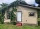 Side view of tan house with vines at 3107 N 24Th St, Tampa, FL 33605
