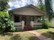 Tan house with front porch and large yard at 3107 N 24Th St, Tampa, FL 33605