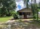 Tan house with front porch and large yard at 3107 N 24Th St, Tampa, FL 33605