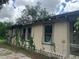 Side view of tan house with vines at 3107 N 24Th St, Tampa, FL 33605