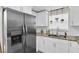 Stainless steel refrigerator in a modern kitchen with white cabinets at 3226 Coldwell Dr, Holiday, FL 34691