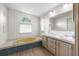Bathroom with double vanity, jetted tub, and separate shower at 34124 Estates Ln, Wesley Chapel, FL 33543