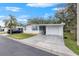 Front view of a white single story home with a carport at 34124 Estates Ln, Wesley Chapel, FL 33543