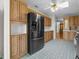 Kitchen with wood cabinets, stainless steel appliances and tile floors at 34124 Estates Ln, Wesley Chapel, FL 33543