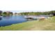 Peaceful lakefront view with a dock and bench at 34124 Estates Ln, Wesley Chapel, FL 33543