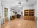 Home office with built-in shelving and wood floors at 34124 Estates Ln, Wesley Chapel, FL 33543