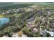 Aerial view of a house and surrounding neighborhood near a golf course and lake at 3922 Cedar Cay Cir, Valrico, FL 33596