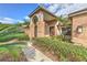 Front entrance with arched brick columns and a wood door at 3922 Cedar Cay Cir, Valrico, FL 33596