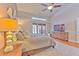 Main bedroom with king bed, wood dresser, and ceiling fan at 3922 Cedar Cay Cir, Valrico, FL 33596