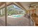 Covered patio with pool, spa, and outdoor kitchen at 3922 Cedar Cay Cir, Valrico, FL 33596