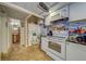 Charming kitchen with stainless steel appliances and tile backsplash, next to a bathroom at 4001 58Th N St # 20, Kenneth City, FL 33709