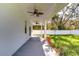 Covered patio with ceiling fans overlooking fenced backyard at 515 Elm St, Safety Harbor, FL 34695