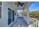 Covered balcony with ceiling fan and view of neighborhood at 515 Elm St, Safety Harbor, FL 34695