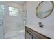 Modern bathroom with marble shower and wood vanity at 515 Elm St, Safety Harbor, FL 34695