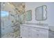 Luxury bathroom with marble shower, double vanity, and gold fixtures at 515 Elm St, Safety Harbor, FL 34695