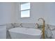 Bathroom boasts a free-standing soaking tub with gold faucet at 515 Elm St, Safety Harbor, FL 34695