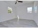 Spacious bedroom featuring grey floors and two windows at 515 Elm St, Safety Harbor, FL 34695