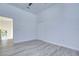 Bright bedroom with grey wood-look floors and ceiling fan at 515 Elm St, Safety Harbor, FL 34695