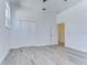Large bedroom with grey flooring and double doors to closet at 515 Elm St, Safety Harbor, FL 34695