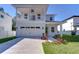 Two-story house with balcony, attached garage, and landscaped lawn at 515 Elm St, Safety Harbor, FL 34695