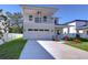 Two-story house with balcony, attached garage, and landscaped lawn at 515 Elm St, Safety Harbor, FL 34695