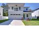 Two-story house with balcony, attached garage, and landscaped lawn at 515 Elm St, Safety Harbor, FL 34695