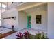 Modern home exterior with teal front door and attached garage at 515 Elm St, Safety Harbor, FL 34695