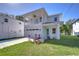 Two-story house with balcony, attached garage, and landscaped lawn at 515 Elm St, Safety Harbor, FL 34695
