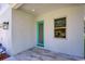 Front entryway with teal door and tiled porch at 515 Elm St, Safety Harbor, FL 34695
